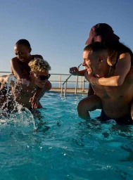 Two couples playing in an outdoor swimming pool on a sunny day, captured by photographer Florian Bison