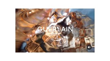 Abstract shot of water-like reflections, creating a textured and shimmering effect, overlaid with the Guerlain logo.