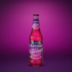 Glass bottle of Thatchers Apple and Blackcurrant cider covered in condensation against a solid purple gradient background.