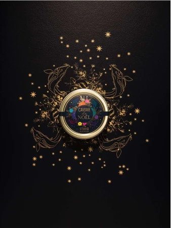 Overhead shot of a caviar tin centered on a black surface, adorned with gold stars, sketched whales, and botanical illustrations.