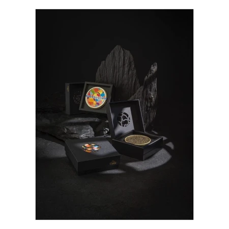 Four open black boxes display caviar, one featuring an abstract art lid, arranged against a dramatic black rock background.
