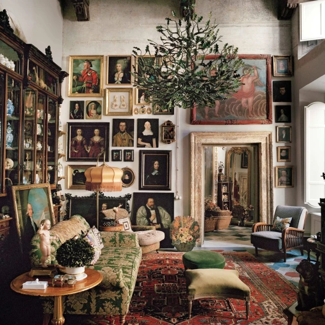 Eclectic living room interior featuring antique furniture, portraits, a vintage rug, and unique lighting fixtures in a home setting.