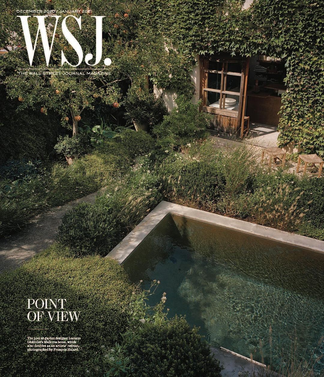 WSJ Magazine cover showing a garden and swimming pool surrounded by dense greenery, with a glimpse into a rustic building.