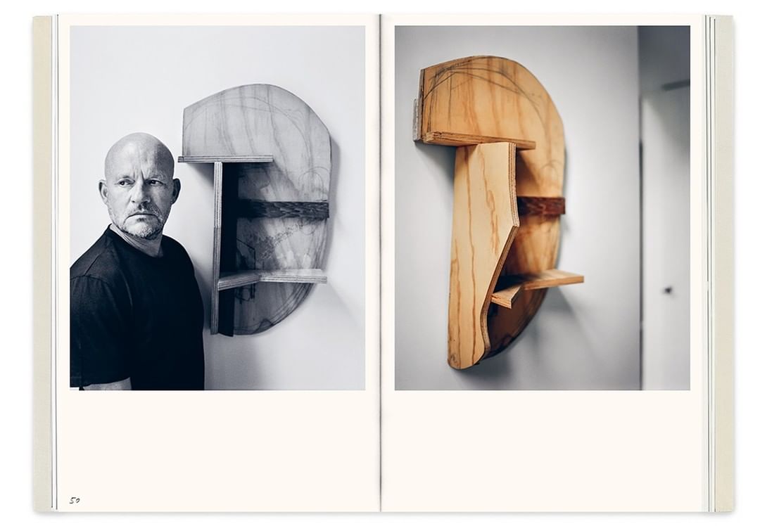 Black-and-white diptych features a man with a shaved head alongside a photograph of an abstract wooden art piece mounted on a wall.