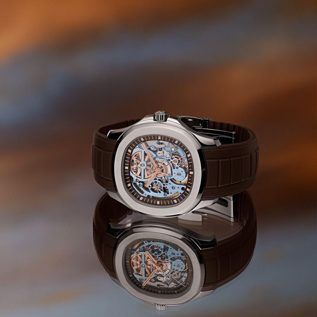 Close-up of a stylish wristwatch with intricate mechanical details on a reflective surface, highlighted against a softly blurred backdrop.