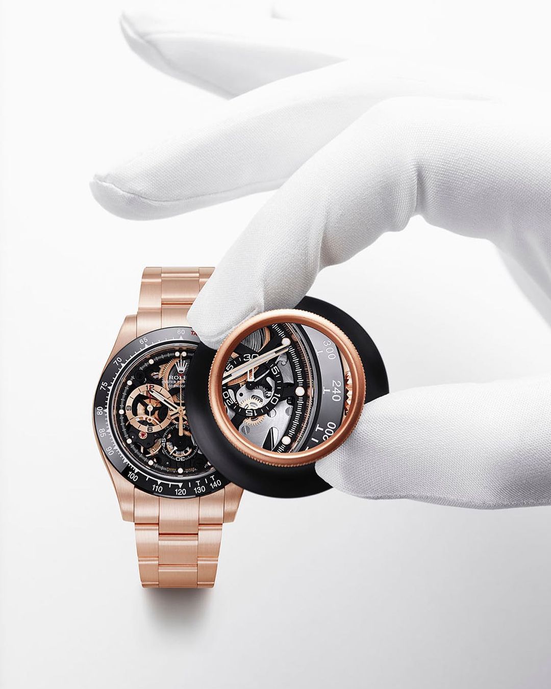 Wristwatch close-up: A rose gold wristwatch is inspected by a gloved hand, enhanced with a lens for horological detail.