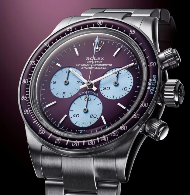 Close-up of a Rolex Oyster Perpetual Superlative Chronometer Daytona watch featuring a stainless steel band, purple dial, and chronograph sub-dials.