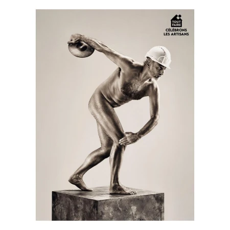 Artisan in nude pose throwing discus while wearing hard hat stands on pedestal against light grey backdrop in studio setting.