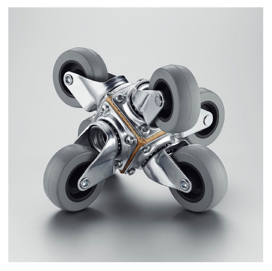 Close-up studio shot of a metallic industrial caster wheel system featuring multiple small gray wheels attached to a central silver metal frame.