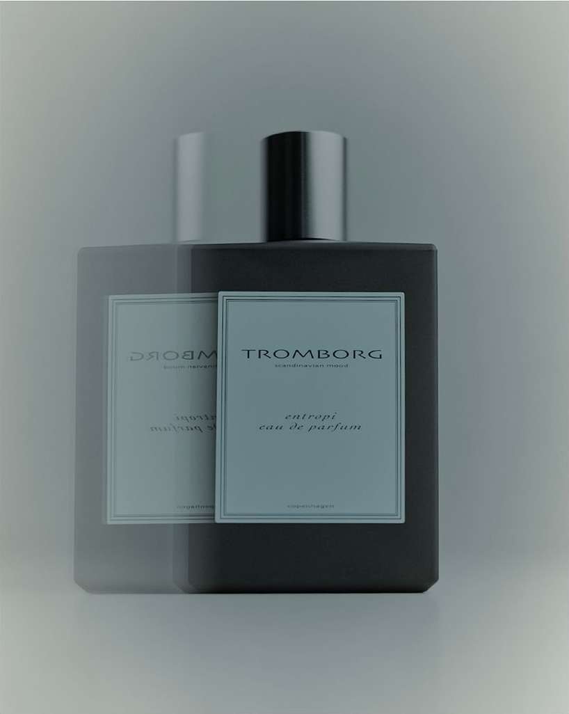Square bottle of Tromborg Entropi eau de parfum, featuring a silver cap and a label with sans-serif typography against a soft, muted background.