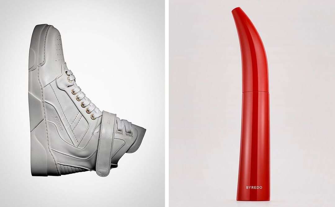 Studio shot of a white high-top sneaker and a red curved mascara tube on a divided white and light grey backdrop, product photography.