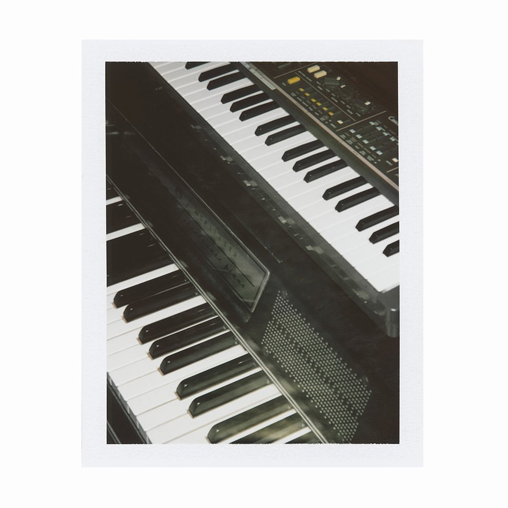 Two vintage electronic keyboards stacked on top of each other in a close-up view. Good for music production, electronic instruments, audio equipment.