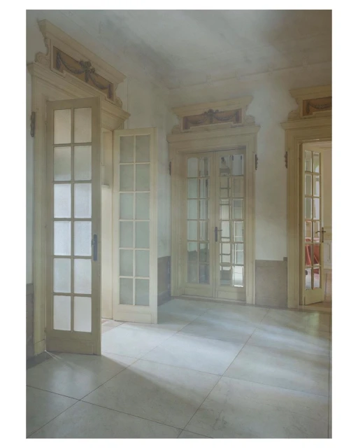 Interior view of a hallway featuring neutral-toned walls, tile flooring, and multiple white French doors leading to adjoining rooms.