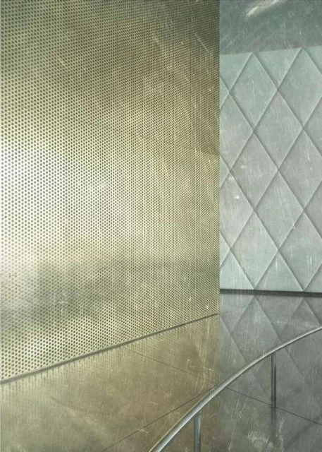 Abstract close-up shot of textured surfaces with a geometric pattern and metallic perforated wall, creating an industrial yet modern aesthetic.