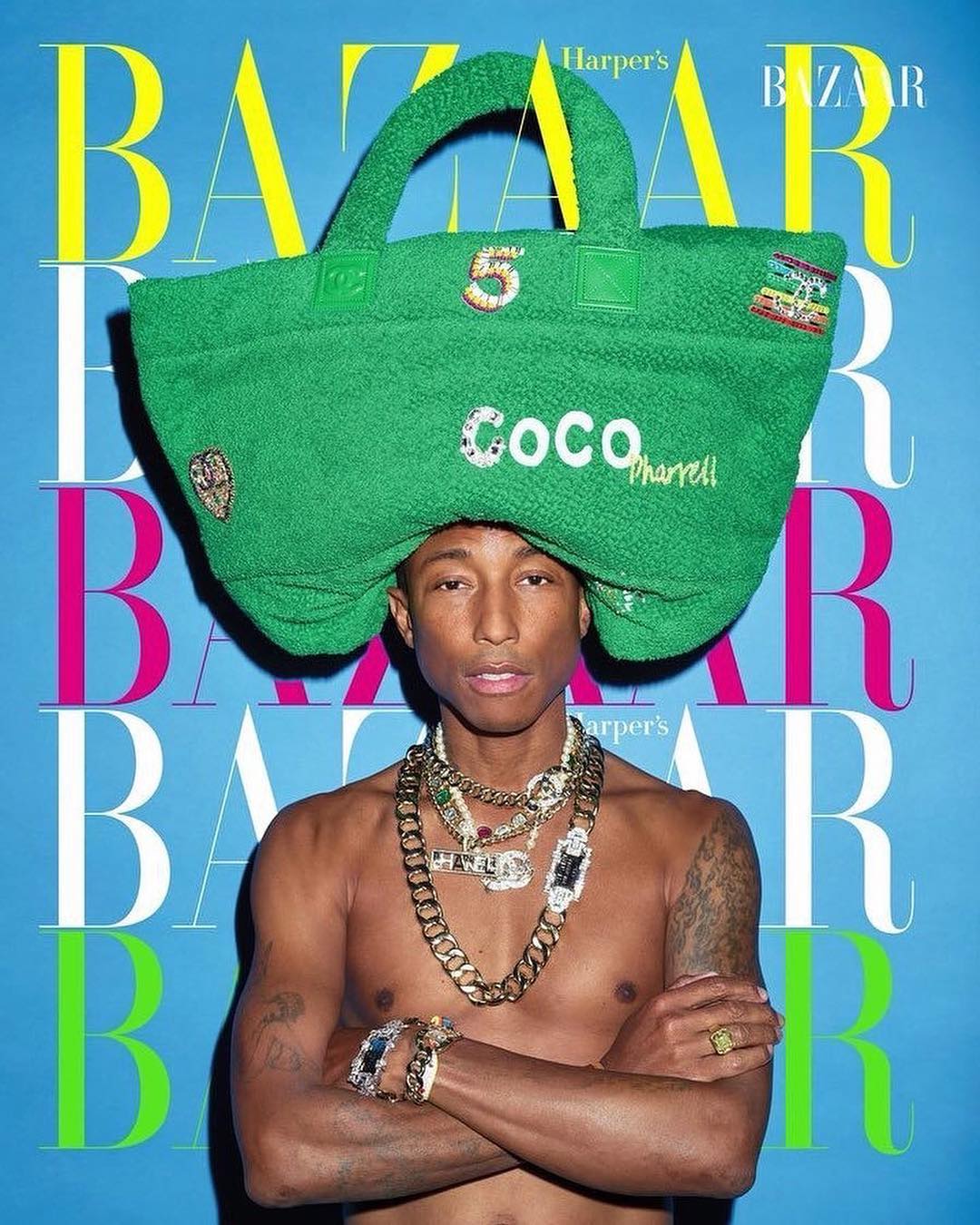 Pharrell Williams on the cover of Harper's Bazaar, wearing gold jewelry and a green novelty tote bag over his head against a blue backdrop.