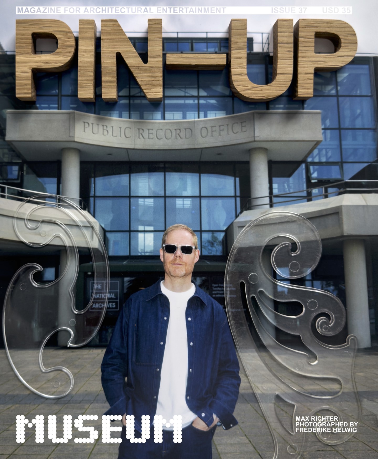 Magazine cover featuring a man in sunglasses standing in front of a building with an architectural office sign, overlaid with stencils.