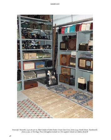 Vintage radios and bags are displayed on shelves. A variety of rugs are on the floor in front of the shelving units. 