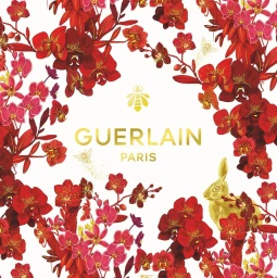 Botanical illustration featuring red orchids, a golden rabbit, and Guerlain Paris branding on white