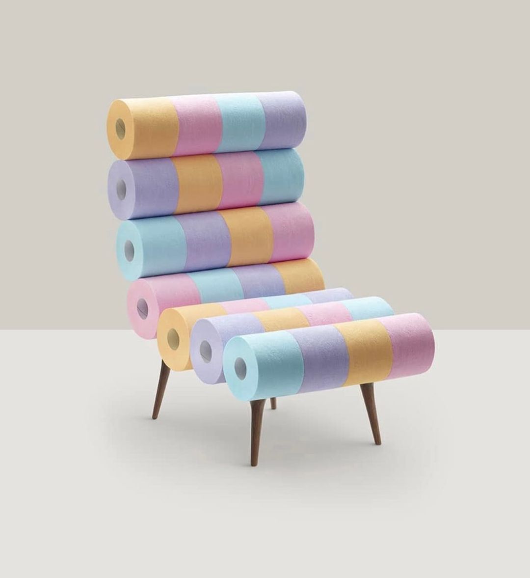 Chair made of pastel-colored striped tubes with wooden legs against a plain background, creative furniture design.