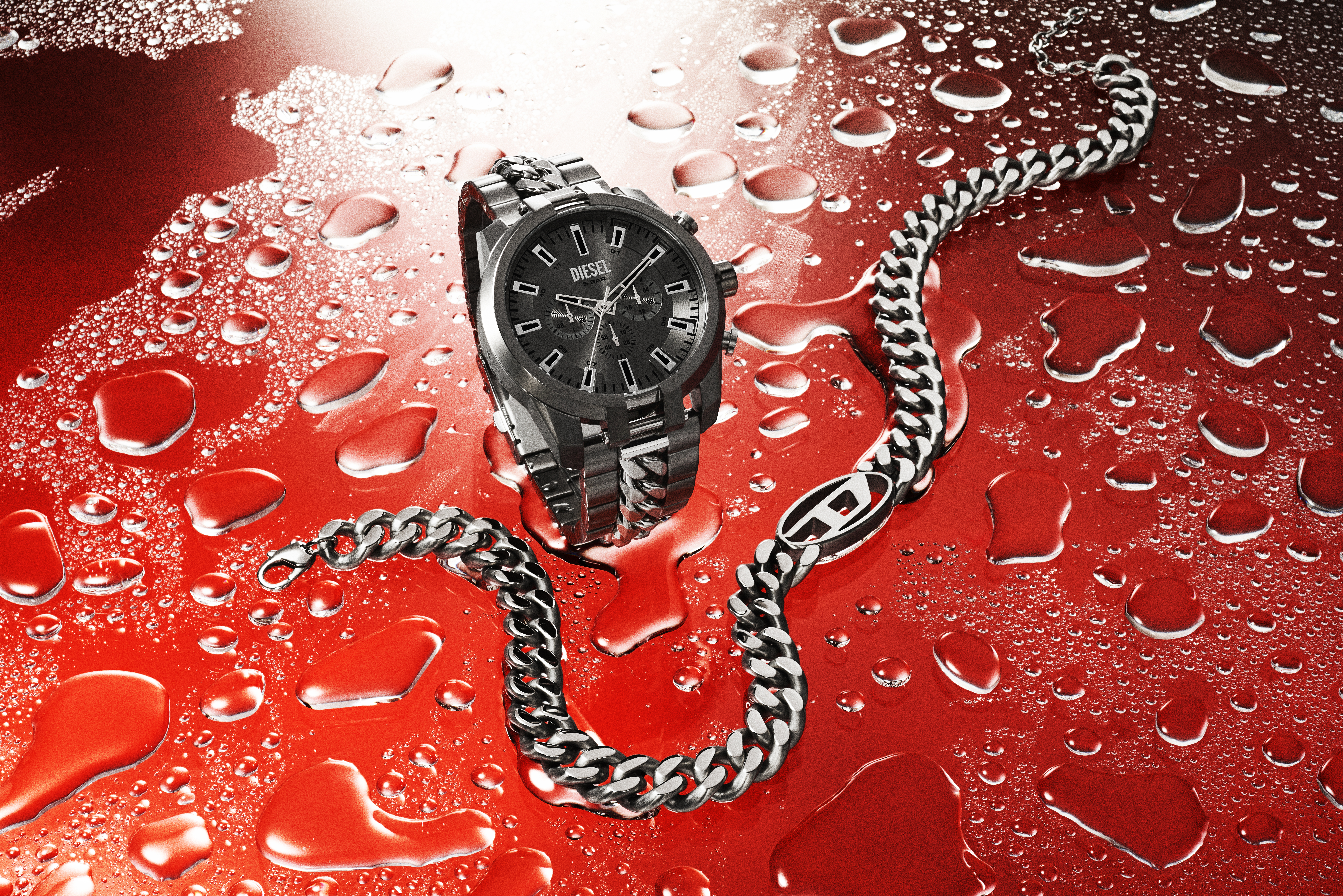 Diesel watch and chain bracelet in a studio shot with red background and water droplets, showcasing modern design and luxury accessories.