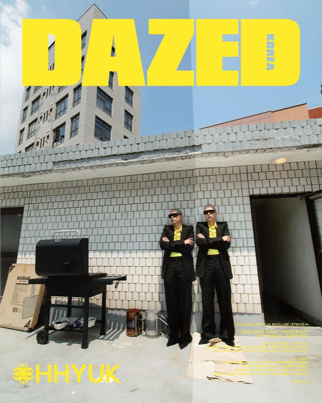 Two men in suits stand on a rooftop by a grill with a building behind them; magazine cover with 'Dazed Korea' and 'OHHYUK' text.