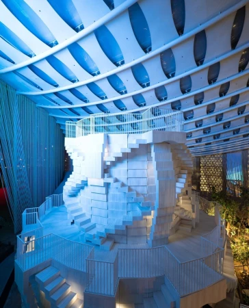Unique architectural design featuring a white sculptural staircase in an interior space with a striking blue and white ceiling structure.