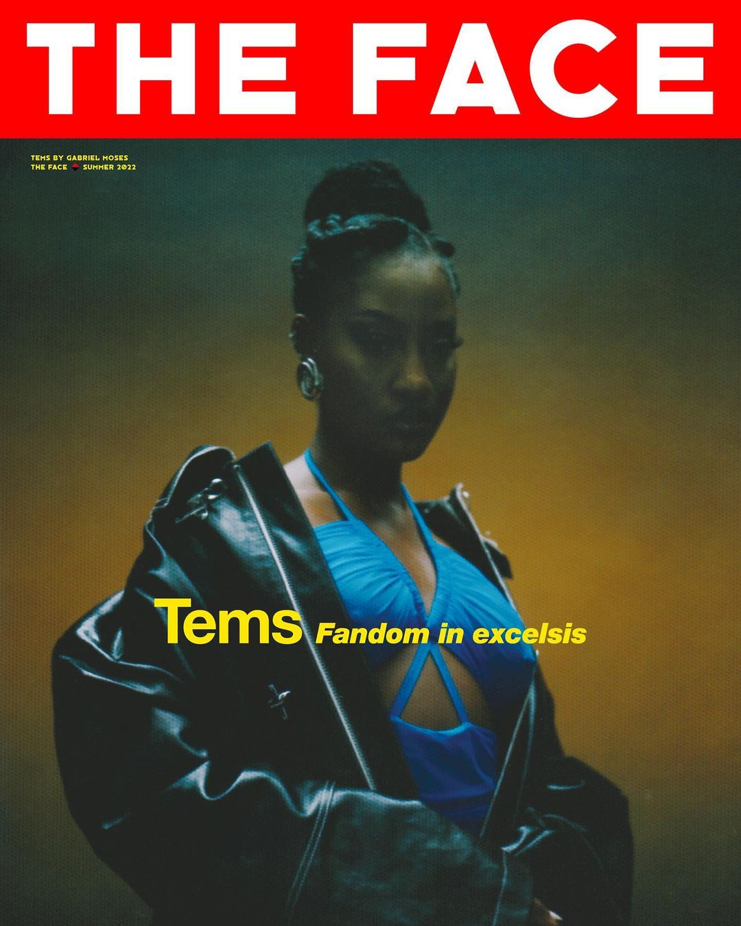 Portrait of a woman wearing a blue top and black leather jacket for The Face magazine cover with red background and yellow text.