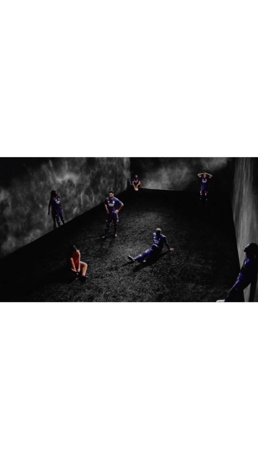 Multiple athletes in sports uniforms scattered in a dimly lit, minimalist indoor space with dark, cloudy background, creating a dramatic scene.