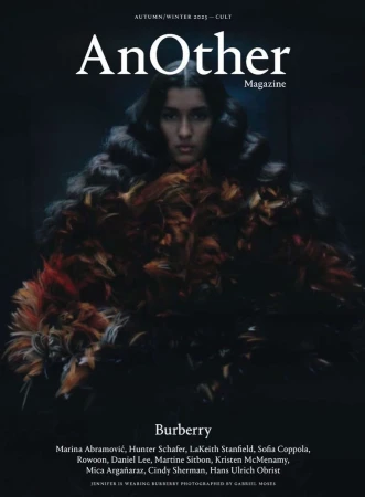 Magazine cover featuring a model wearing a feathery garment, with 'AnOther Magazine' and Burberry branding against a dark background.
