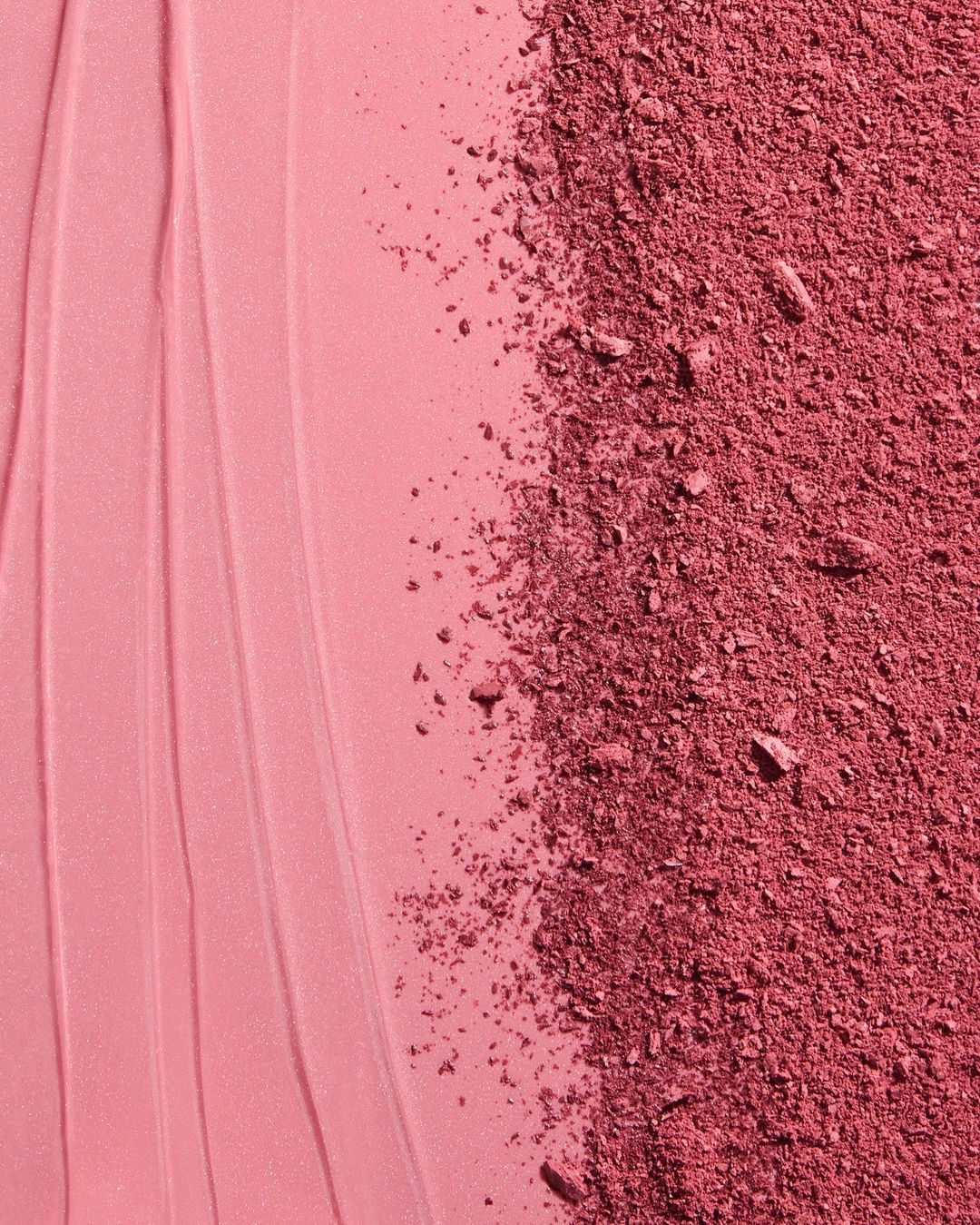 Macro shot of cosmetic blush product featuring a smooth cream texture alongside a section of crushed powder blush makeup.