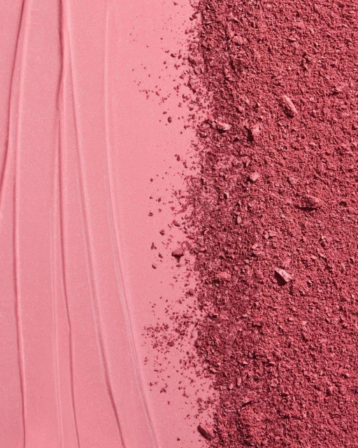 Macro shot of cosmetic blush product featuring a smooth cream texture alongside a section of crushed powder blush makeup.