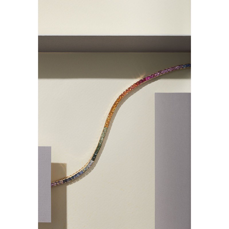 Rainbow sapphire bracelet on a beige geometric background, studio lighting, high angle view, Jewelry and Fashion photography.