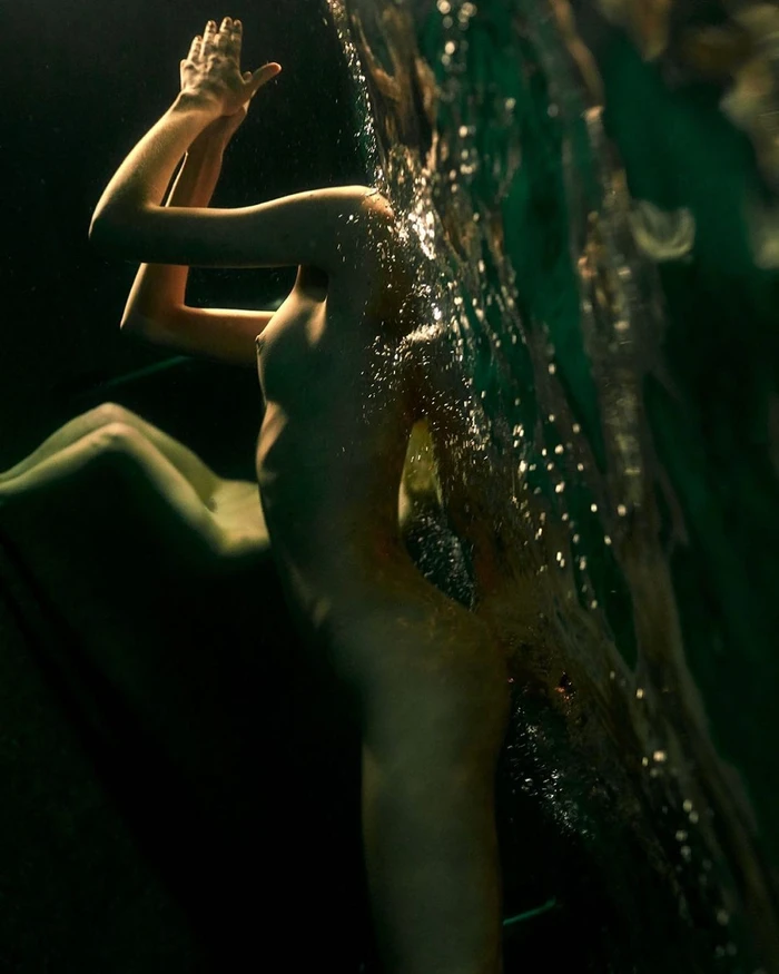 Underwater portrait by Gaspar Noe in Paris featuring a figure submerged with hands raised near the surface