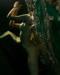 Underwater portrait by Gaspar Noe in Paris featuring a figure submerged with hands raised near the surface