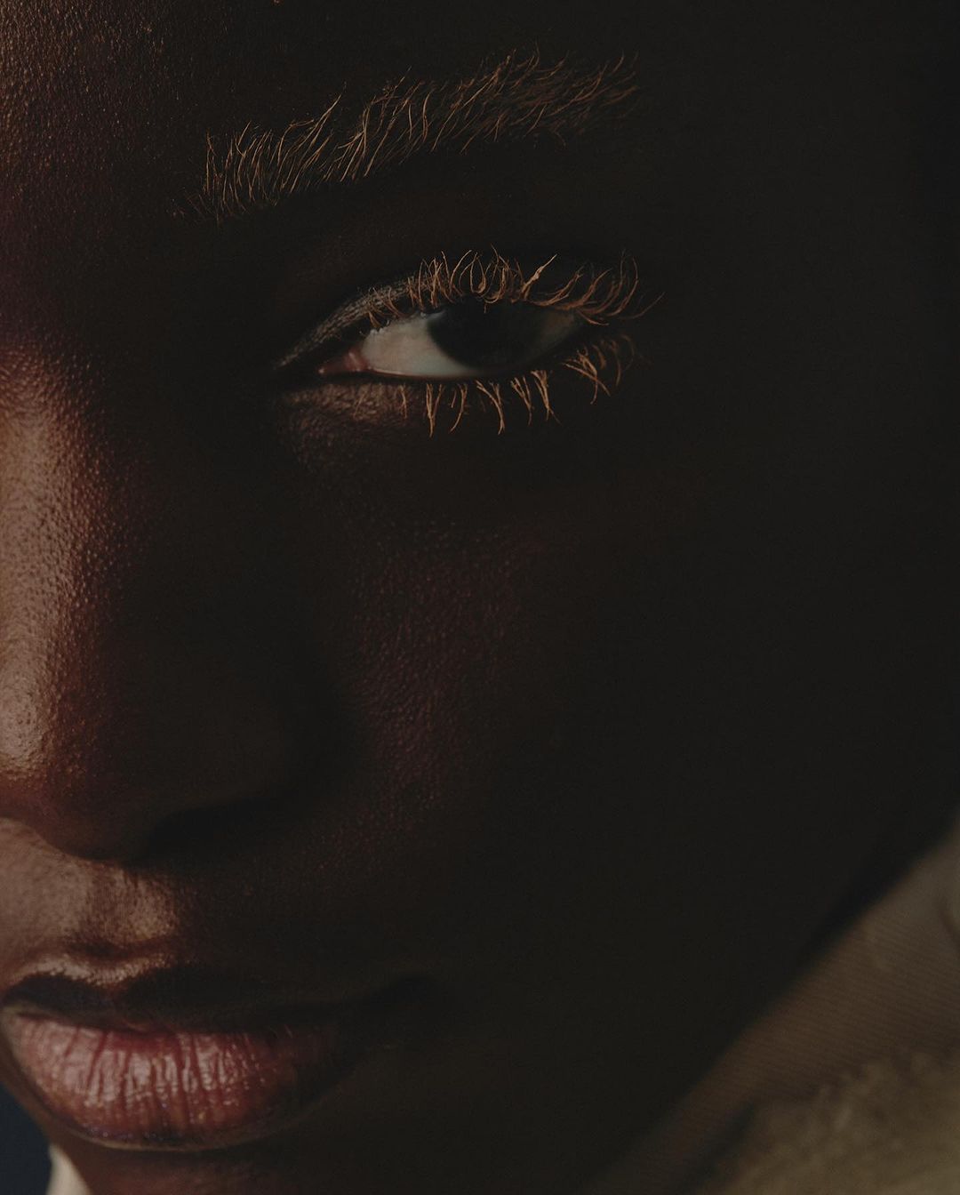 Close-up portrait of a Black model with bleached eyebrows and eyelashes by photographer Gautier Pellegrin in Milan