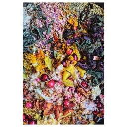 Close-up overhead photograph of scattered dried herbs, spices, berries, and colorful flower petals by Gentl And Hyers.