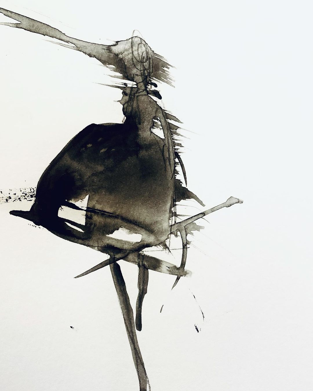 Abstract ink painting features a dark figure formed by dripping ink on a white background, showcasing a dynamic, free-flowing style.