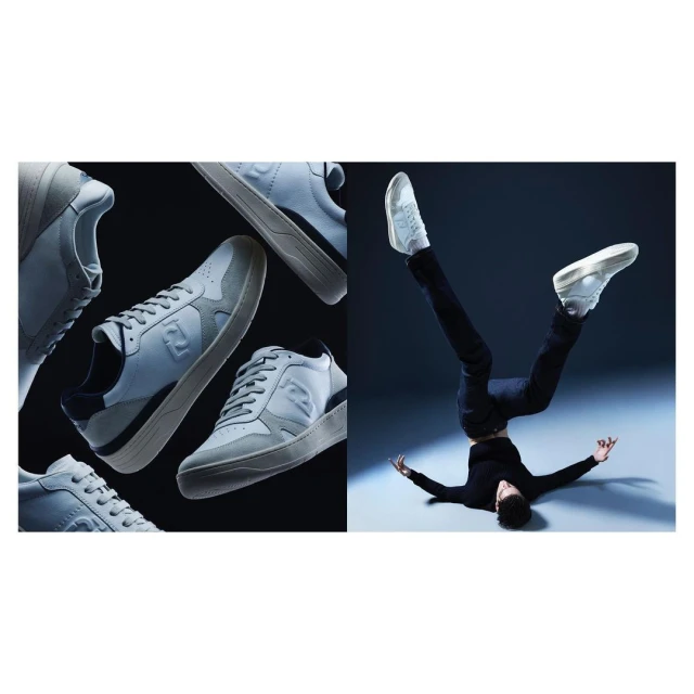 A split studio product shot showcases several light gray Fendi sneakers on a black backdrop next to a man balancing upside down on his head.