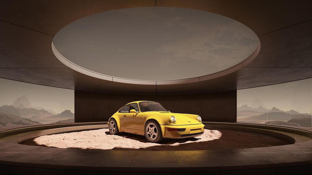 A yellow Porsche 911 sits on a rotating platform inside a minimalist showroom with desert landscape displayed on the surrounding screen.