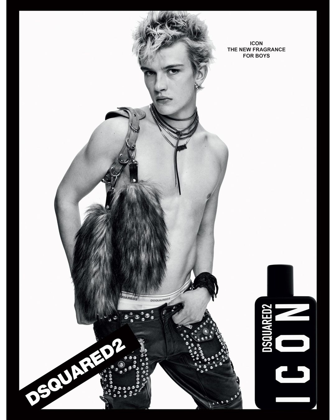 Black-and-white fashion shot features a young male model posing shirtless with studded pants and a fur accessory, plus a Dsquared2 Icon fragrance.