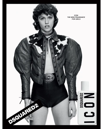 A young woman poses in a black and white fashion shot, wearing a leather jacket and shorts, advertising a perfume.