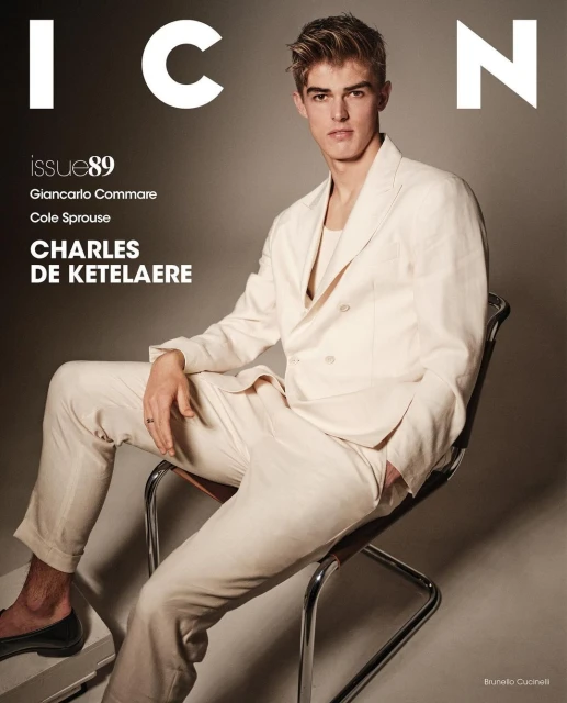 Magazine cover featuring a young adult male model in a cream-colored suit, sitting in a chair against a neutral backdrop with brand logos.