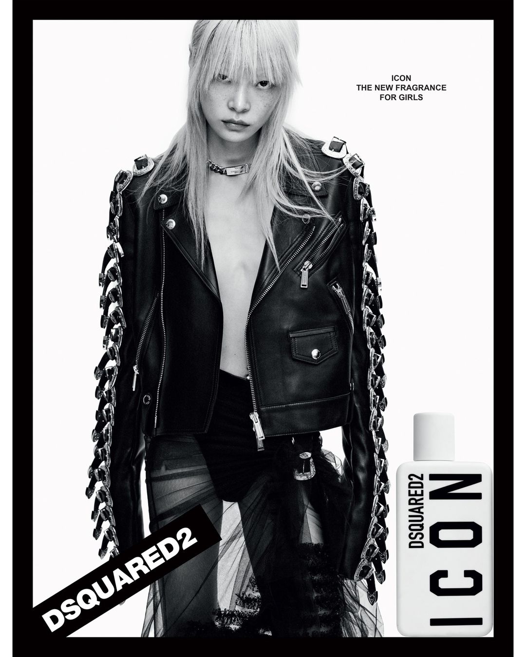 Fashion shot featuring a woman with platinum blonde hair, wearing a black leather jacket, in a high-contrast black and white photo studio setting.