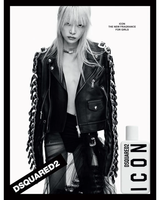Fashion shot featuring a woman with platinum blonde hair, wearing a black leather jacket, in a high-contrast black and white photo studio setting.