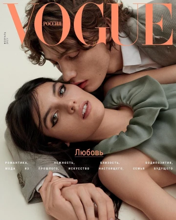 Vogue Russia cover featuring a close-up portrait of a young adult couple, the man kissing the woman's temple; warm skin tones, soft lighting.