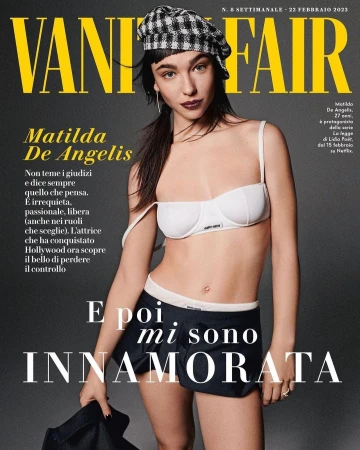 Matilda De Angelis wearing a white bra top and dark shorts with a checked beret on a grey background for Vanity Fair magazine cover.