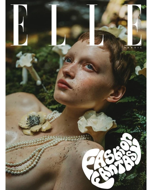 Elle Brazil cover featuring a young woman with fair skin adorned with pearls and mushrooms in a lush green forest setting.