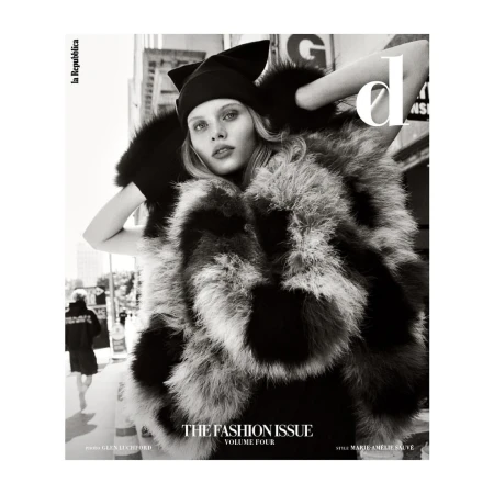 Monochrome fashion magazine cover featuring a model in a fur coat and hat against an urban backdrop, with the publication name visible.
