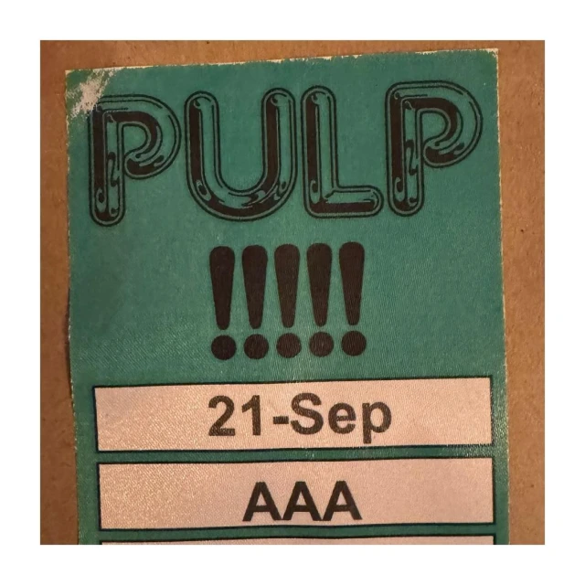 Pulp ticket graphic with bold text and exclamation points on a light teal background, featuring the date September 21 and the code AAA.