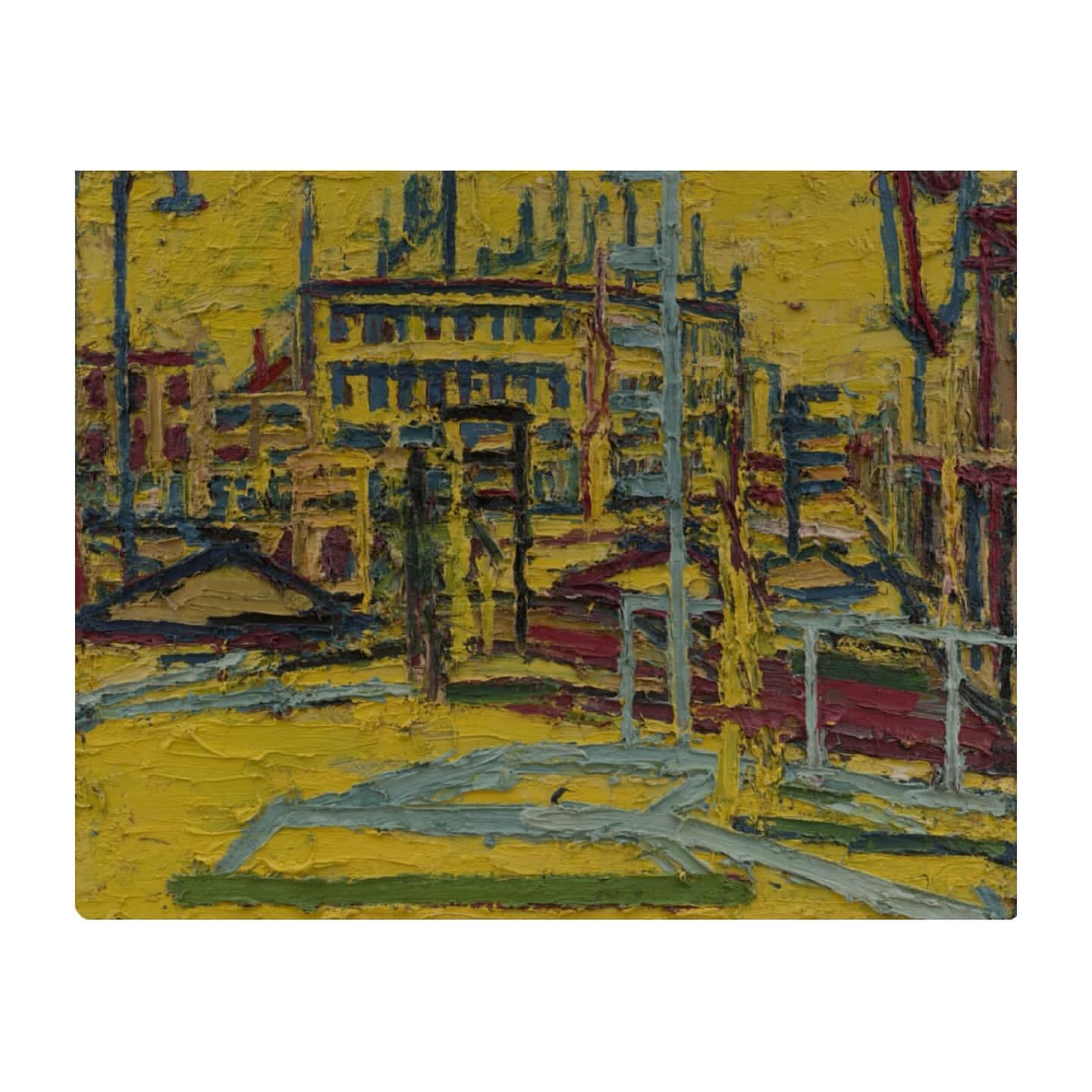Impressionist painting of an urban landscape featuring buildings, streets, and indistinct structures in a palette of yellows, blues, and reds.